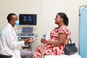 Mariam, who has a vision impairment, consults with a radiographer during her routine antenatal visit at the Comprehensive Community Based Rehabilitation in Tanzania (CCBRT) Hospital in Dar es Salaam in December 2023.  © WHO / Mwesuwa Ramsey